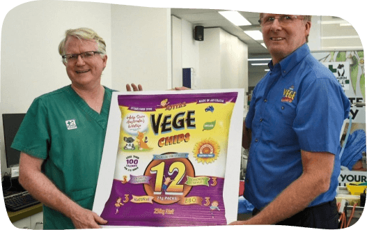 Two men proudly display a box