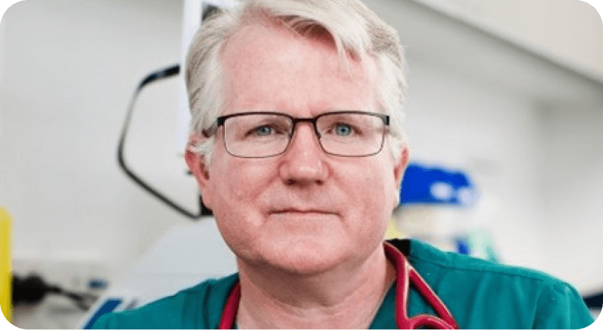 A man in a green shirt and glasses