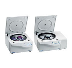 Two open laboratory centrifuges side by side.