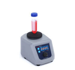 Laboratory vortex mixer with a red liquid-filled test tube.