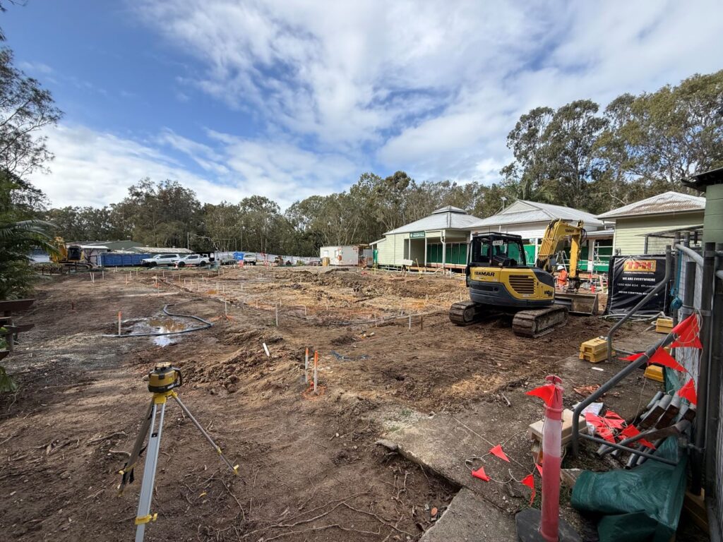 Diggers on a construction site on a sunny blue day in front of Currumbin Wildlife Hospital